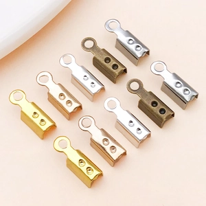 Close-up of metal cord ends for jewelry making in gold, silver and bronze colors