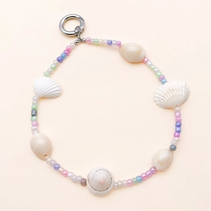 Close-up of handmade sea shell necklace with colorful beads and silver metal clasp