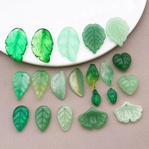 Assorted green glass leaf pendants including ginkgo and jagged leaves for DIY jewelry