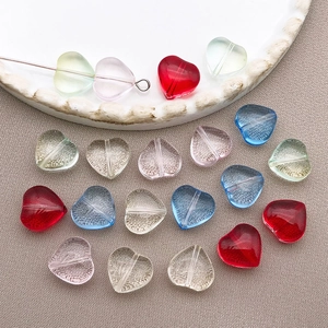Macro shot of 10mm multi-colored heart glass beads for DIY jewelry with hole detail