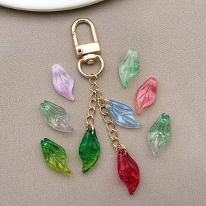Macro detail of mixed color glass flower petal pendants on a golden keychain