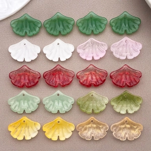 Flat lay of 20 multicolor resin ginkgo leaf pendants for DIY jewelry making kits