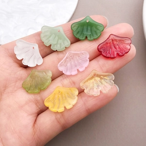 Detailed close-up of colorful ginkgo leaf glass pendants for DIY jewelry making
