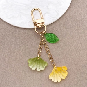 Detail of ginkgo leaf keychain with translucent resin charms and gold alloy hook