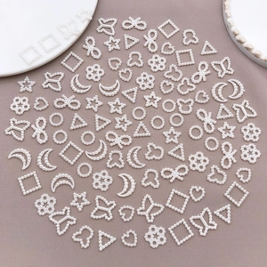 Assorted white faux pearl acrylic charms in heart moon star shapes for DIY nail art and crafts