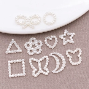 Macro shot of assorted hollow pearl charms for DIY nail art and phone case decoration