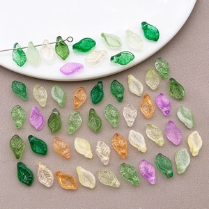 Close-up of leaf-shaped colorful glass beads with detailed veins for DIY jewelry making