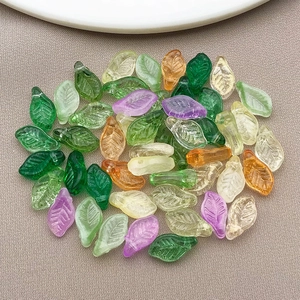 Macro view of assorted colorful glass leaf beads with detailed vein textures for DIY crafts