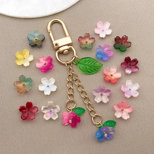 Macro shot of 10mm gradient glass cherry blossom charms for handmade DIY keychains