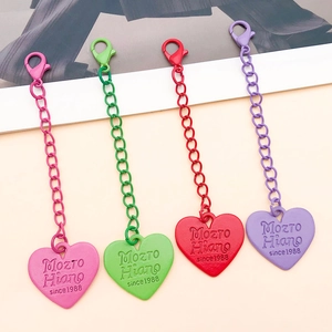 Detail of colorful zinc alloy lobster clasp heart pendants in pink, green, red, and purple