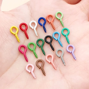 Assorted colorful iron screw eye pins for DIY jewelry making shown in hand for scale