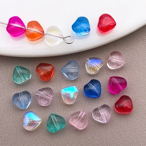 Detailed macro of 6mm candy-colored glass heart beads with aurora coating for DIY jewelry