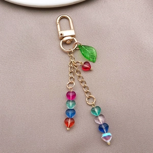 Detailed view of candy-colored heart glass beads on a gold keychain with D-ring clasp