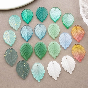 Close-up of assorted color glass leaf pendants with gold foil and vein details