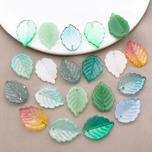 Mix of leaf shaped glass pendants with gold foil accents for DIY jewelry making crafts