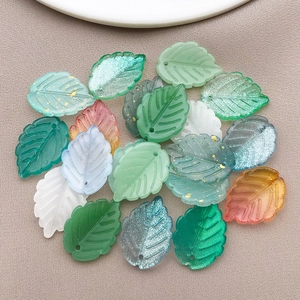 Detailed view of colorful glass leaf pendants with gold foil and fine vein textures