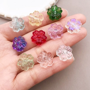 Macro detail of mixed color 13mm cherry blossom glass beads held in hand for DIY jewelry