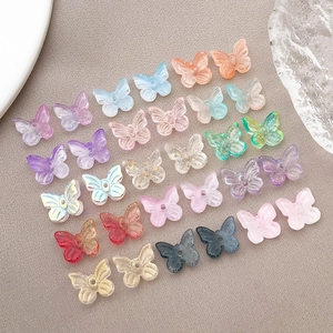 Flat lay detail of 10x11mm colorful glass butterfly beads for DIY jewelry making