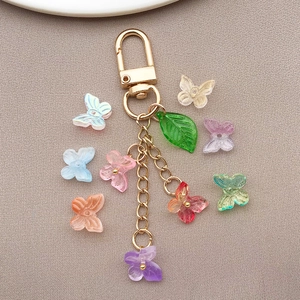 Detail of colorful transparent glass butterfly charms with golden keychain links