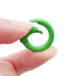 Macro view of a 20mm green painted zinc alloy spring O-ring buckle for DIY bags