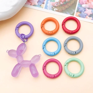 Detailed view of colorful 20mm zinc alloy spring rings and resin glitter balloon dog pendant