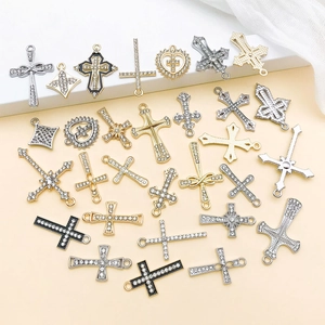 Detailed macro view of assorted cross and heart alloy charms with sparkling rhinestones