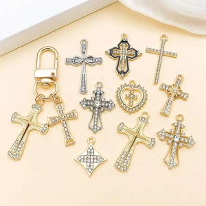Detailed flat lay of gold and silver alloy cross pendants with sparkling white rhinestones