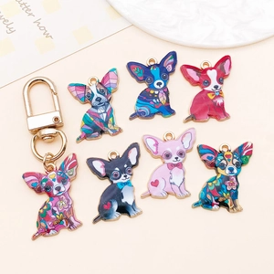 Macro shot of colorful enamel chihuahua charms with diverse patterns on a beige background