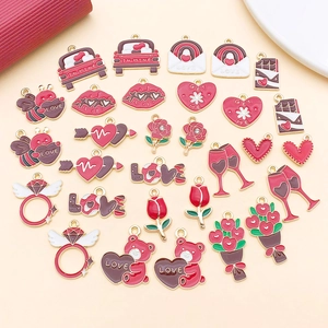 Detailed close-up of Valentine's Day themed enamel charms for DIY jewelry making