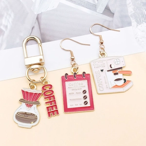 Detail view of coffee-themed alloy charms featuring drip oil enamel drip kettle and machine