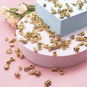 Macro shot of antique gold DIY jewelry connectors with ornate embossed floral textures