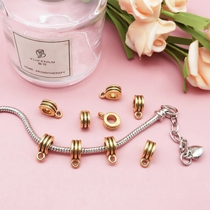 Macro view of antique gold large hole connector beads with small ring on snake chain