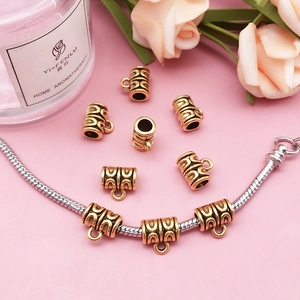 Macro shot of antique gold large hole bead with wave texture on snake chain