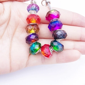 Macro shot of colorful faceted glass beads on a silver snake chain bracelet