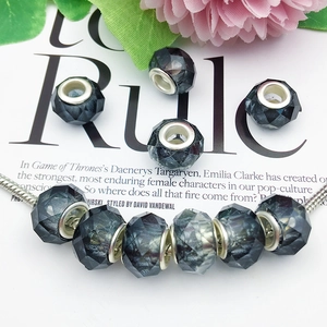 Macro view of faceted dark grey large hole beads with silver core on a snake chain
