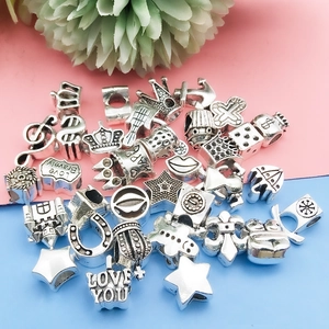 Mix of vintage silver alloy charms for DIY bracelets with stars, crowns and charms