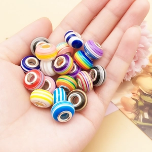 Detail of colorful striped resin beads with silver metal cores for DIY jewelry bracelets