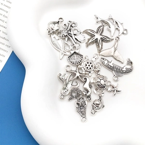 Macro view of ocean animal charms including dolphins and starfish for DIY jewelry