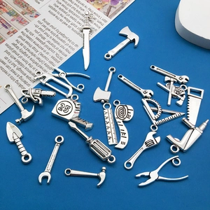 Macro detail of various antique silver alloy tool pendants for DIY jewelry making