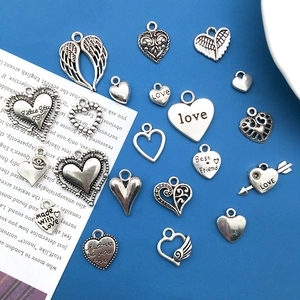 Collection of 20 vintage silver alloy heart and wing charms for DIY jewelry making