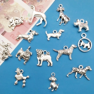 Vintage silver dog alloy charms for DIY jewelry making in multiple breeds on blue background