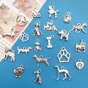 Assorted silver-colored dog breed charms and paw prints for DIY necklace making