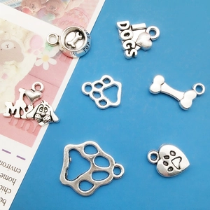 Detailed collection of silver alloy dog charms including paw prints and bone shapes