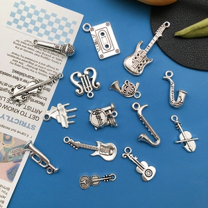 Vintage silver musical instrument pendants set including guitar, violin and microphone
