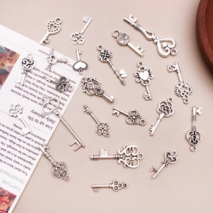 Macro shot of 20 vintage silver alloy key pendants featuring heart and clover shapes