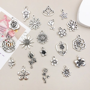 Assorted vintage silver alloy flower pendants featuring rose and daisy designs for DIY jewelry