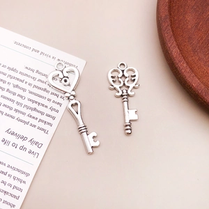 Detailed close-up of retro silver alloy key pendants with heart and floral designs
