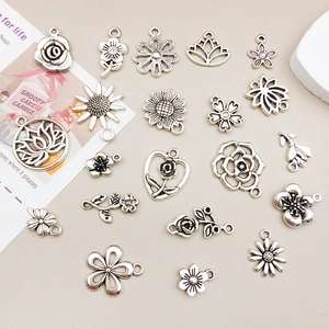 Detailed macro view of antique silver alloy flower charms for DIY jewelry making