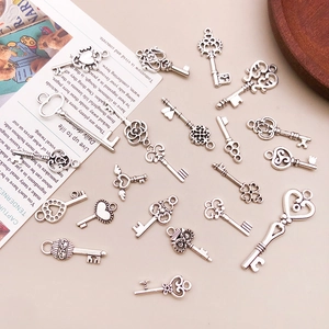 Detailed view of antique silver alloy key charms and heart pendants for DIY jewelry making