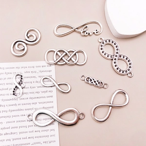 Macro shot of antique silver infinity charms for DIY jewelry making accessories